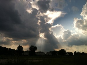 Light shines brightly behind the clouds.